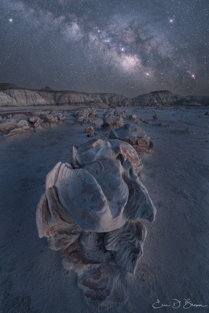 Rounded, cracked stone formations known as the alien eggs sitting on the desert floor at Bisti Badlands, New Mexico.