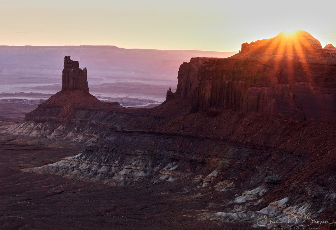 Panoramic sunset over the Green River and the White Rim from Green River Overlook in Canyonlands National Park, soft color in the sky and last light on the canyon rock.