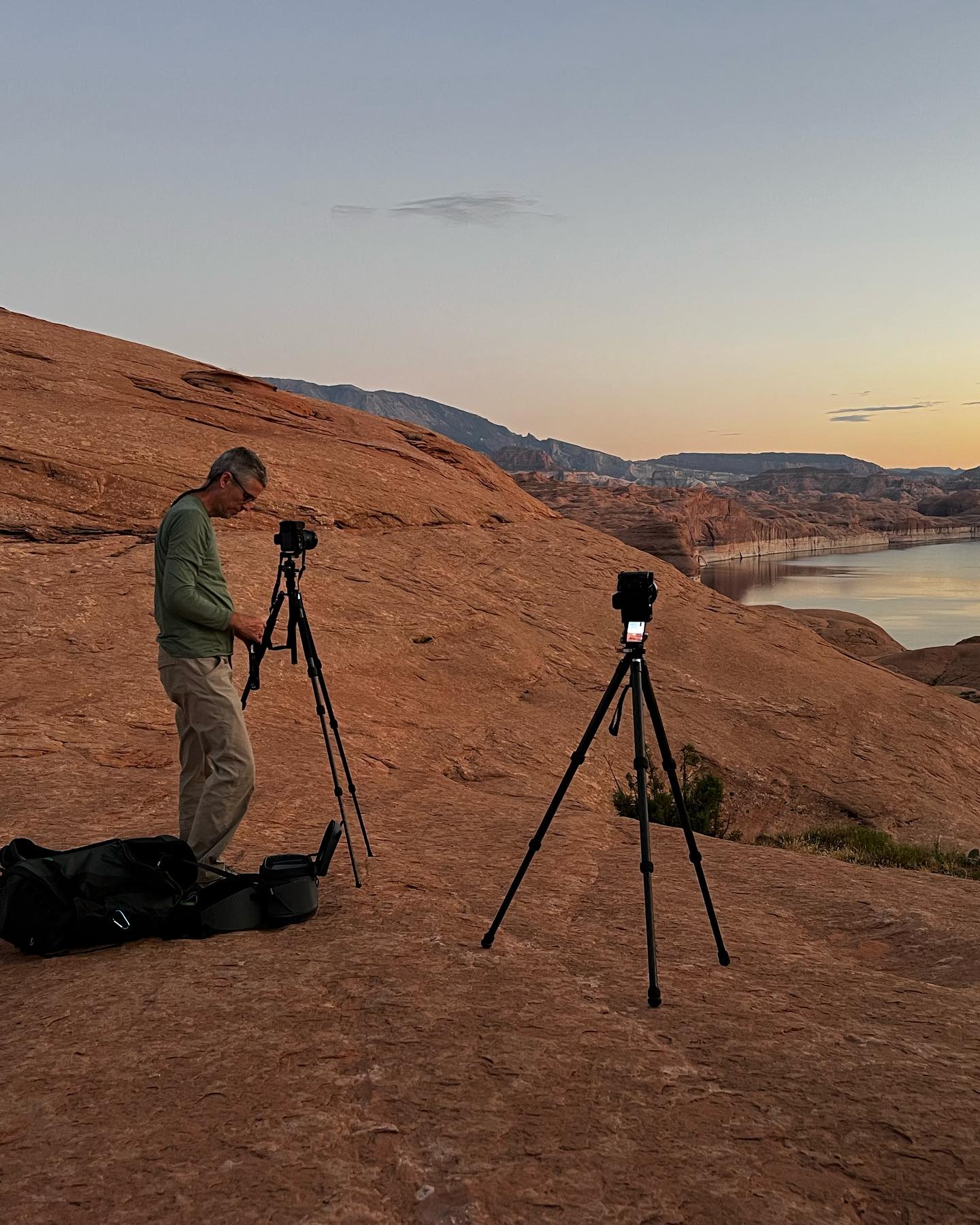Adjusting a camera on a tripod at the Reflection Canyon overlook