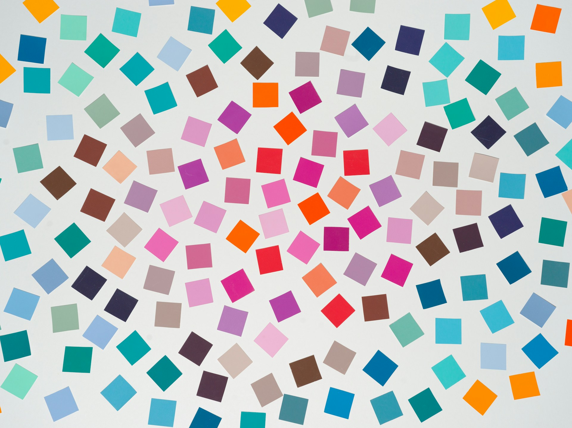 A grid of small multicolored squares repeating across a white background